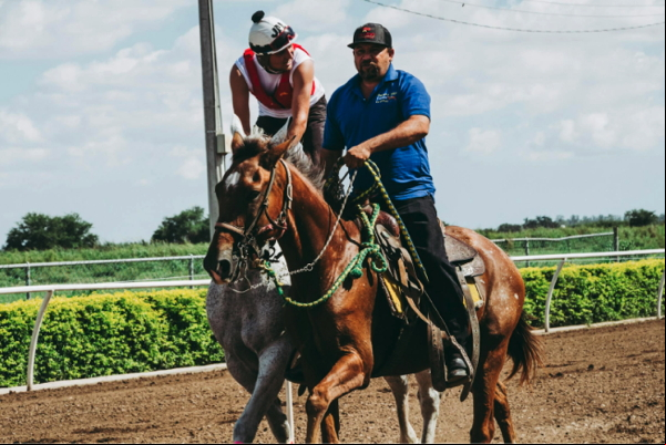 Two Men Riding a Horse on a Course